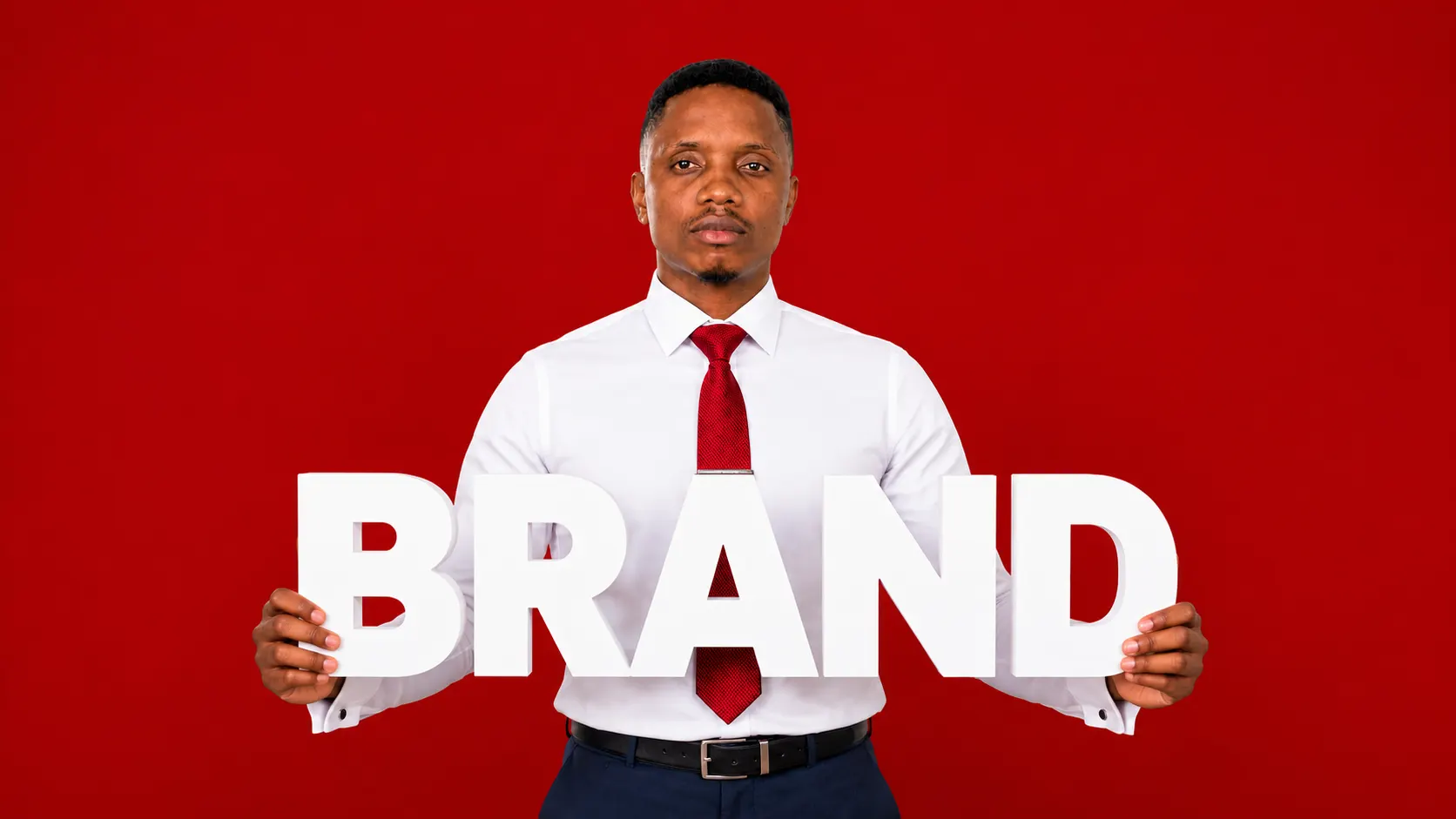 Omar Stone holding the word brand